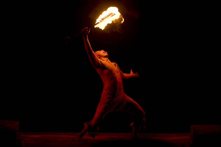 A Hawaiian fire dancer illuminates the night during a private Hawaiian tour held in late July.