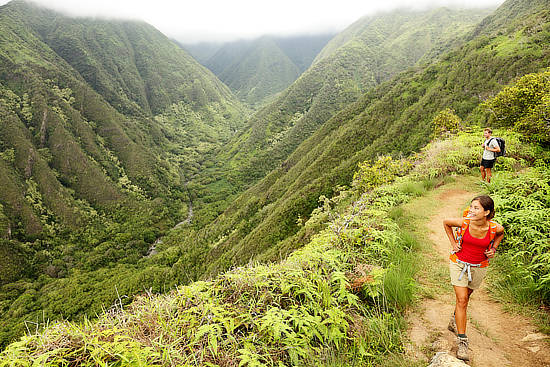 Two backpackers hike the Waihee ridge trail in Maui during their private Hawaii tour.