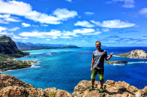 A local tour guide stands on Makapuu Point overlooking pristine beaches, during our "Hang Loose" tour offered as one of many private Oahu tours.