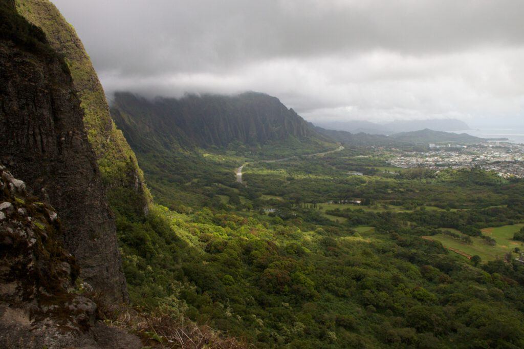 Oahu's mountains peaks tuck into clouds as the lush valley below gives way to Oahu's iconic North Shore, featured in our private Oahu tours.